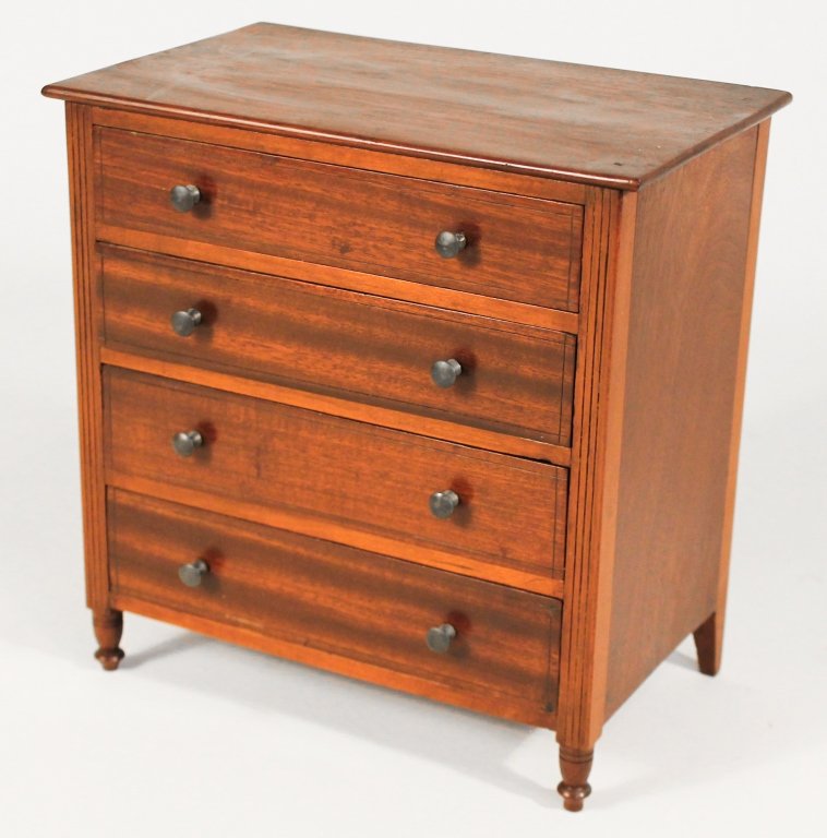 Sheraton Mahogany Miniature Chest of Drawers: American, circa 1830. rectangular top above conforming chest with four graduated drawers on turned legs. H9 3/4" W9 5/8" D5 7/8" Private Upcountry, South Carolina Collection.