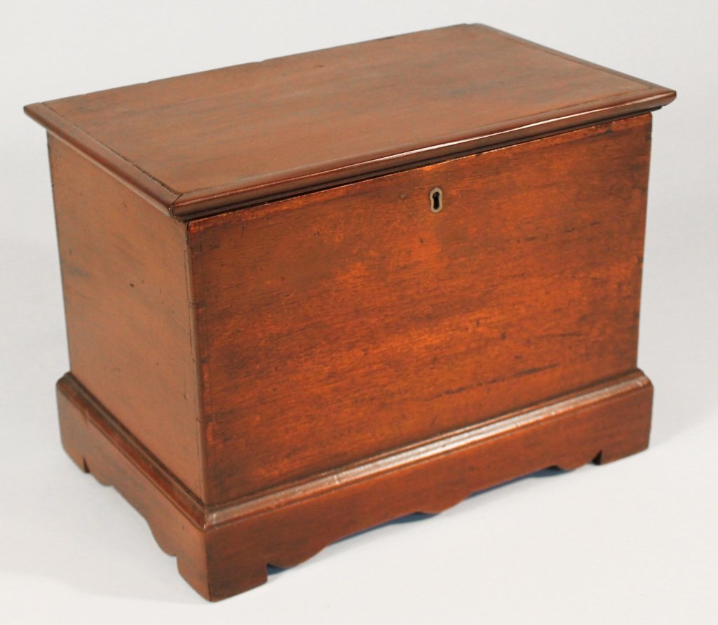 Chippendale Style Miniature Mahogany Blanket Box: 19th century. The dovetailed box with hinged and molded top opens to reveal two divided trays, the box on bracket base. H9 1/4" W12 1/4" D7 3/4" Private Upcountry, South Carolina Collection.