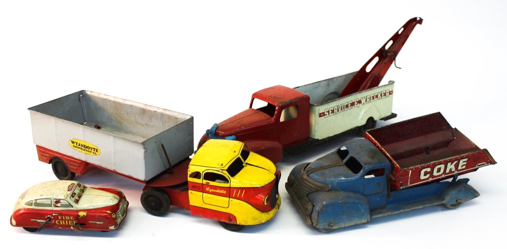 Group of Four Vintage Tin Toy Trucks: consisting of Coke/Coal dump truck, Wyandotte Construction Company Semi, service wrecker and Courtland Fire Chief Car. Private collection of Mr. CC Canada, Camden, SC