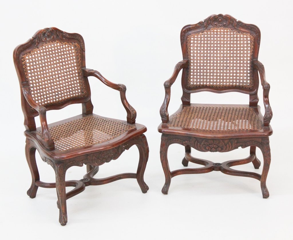 Pair Louis XV Style Mahogany Youth Bergeres: Paris, 20th century. faithful reporductions of Louis XV chairs with carved crestrail, arms and legs; cane backs and seats. impressed stamp : "AGR_ Paris (AG Reeditions).H26 3/4" SH11 1/2" W18" D16"