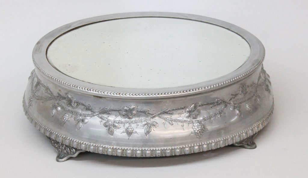Antique British Victorian Pewter Cakestand: late 19th century. with chased floral detail surrounding mirrored surface. unmarked. H5 1/4" W19 1/2"