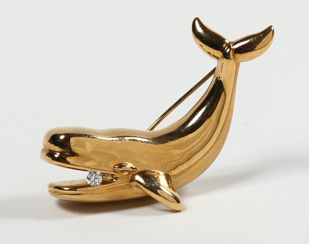 Tiffany & Company Figural Gold & Diamond Pin: handsome figure of a sperm whale with ¼ ct diamond in its mouth, marked on verso Tiffany and Co 1988, 750 or 18k gold. .6 oz standard L1 ¾" Estate of Dale K. and Judy Firestone Thiel.
