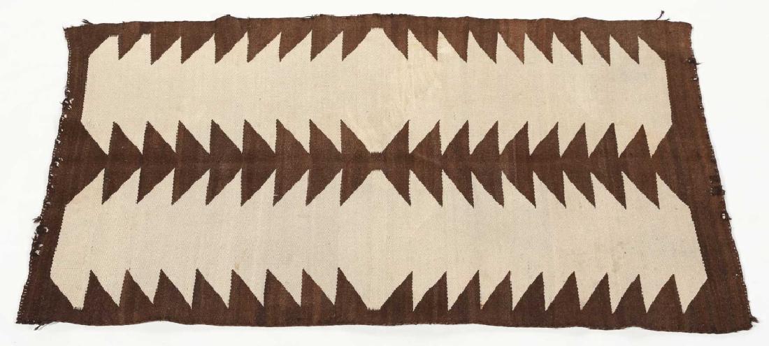 Vintage Navajo Woven Wool Rug: early 20th century. handsomely crafted brown and white pattern. L53 1/4â€ W43 1/4â€ Collection of Barry B. Taylor, Greenville, South Carolina.