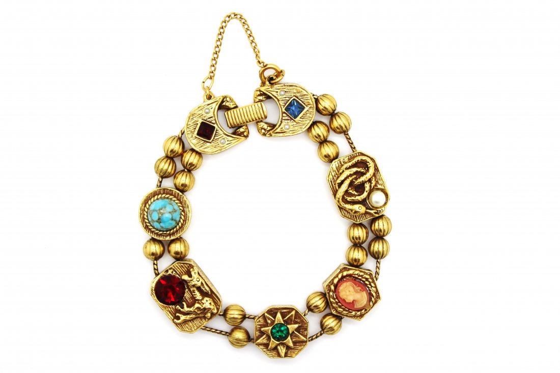 Goldette Gold Tone Slider Charm Bracelet: Vintage Goldette gold tone slider charm bracelet with safety chainrn Features a cameo, serpent, rabbit, star & faux turquoise charms separated by gold beadsrn Measures 8" in length & 1/2" widern Good