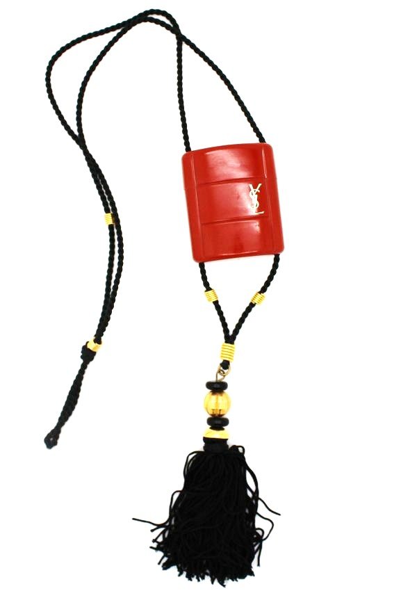 Vintage YSL Yves Saint Laurent Opium Perfume Bottle: Vintage Yves St Laurent Opium fringed pendant necklace Necklace fits over the head & the pendant opens to reveal a mini bottle of Opium perfume with perfume inside Cord measures approx 27.5" long, the