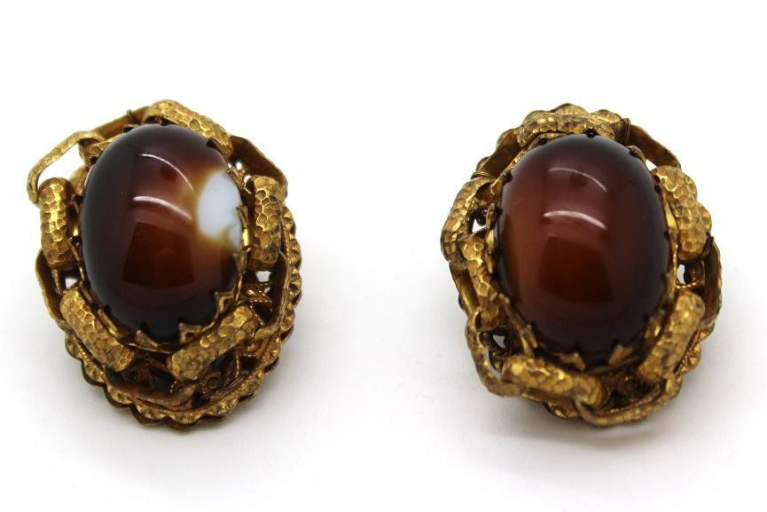 Vintage Miriam Haskell Gold & Brown Earrings: Gold tone with link chain design around center. Brown center stone with one having white on it. It does not feel chipped as it is smooth. Slight patina on back. Measure 1 1/2" in diameter.