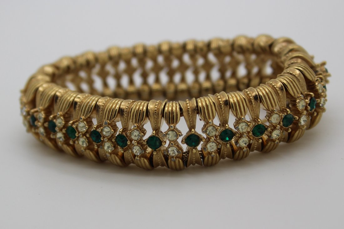 Vintage Ciner Gold & Rhinestone Tennis Bracelet: Signed Ciner gold tone large tennis bracelet. Green & clear rhinestones in the center. Measures 9" in length & 3/4" wide. Great condition.