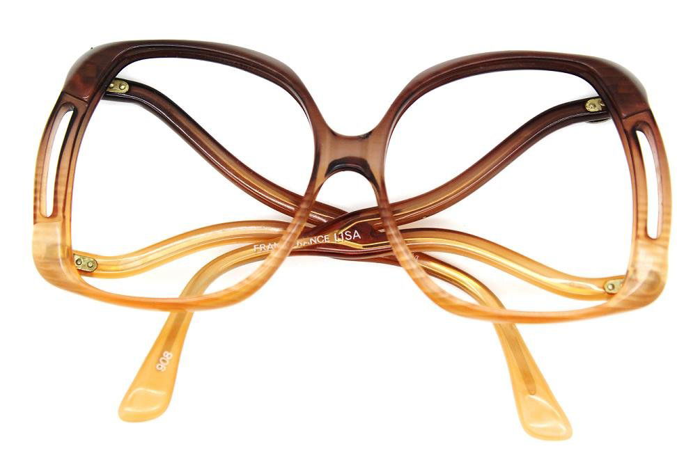 Vintage Diane Von Furstenberg Oversize Frame Glass: Large rectangle shape frames with wide V-shape at the templern Plastic frames, with DVF logos at each temple sidern Dark brown at the top of frame & cascades into a lighter brown at the bottom rn Meas