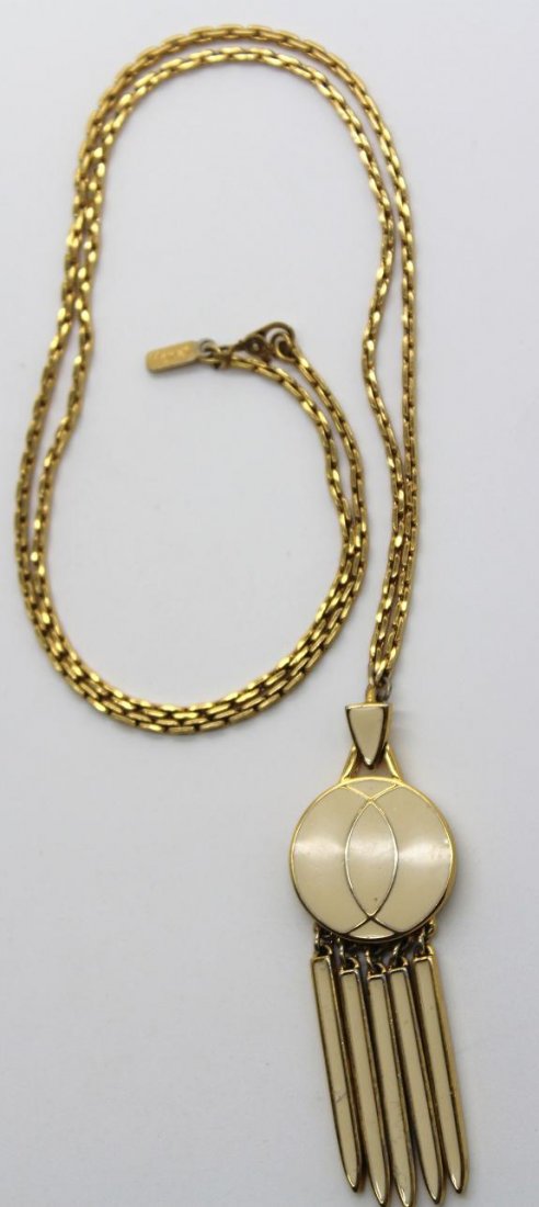 Vintage Monet Gold Tone Enamel Spike Necklace: Signed Monet gold tone & beige enamel spike pendant necklace. 26" in length.