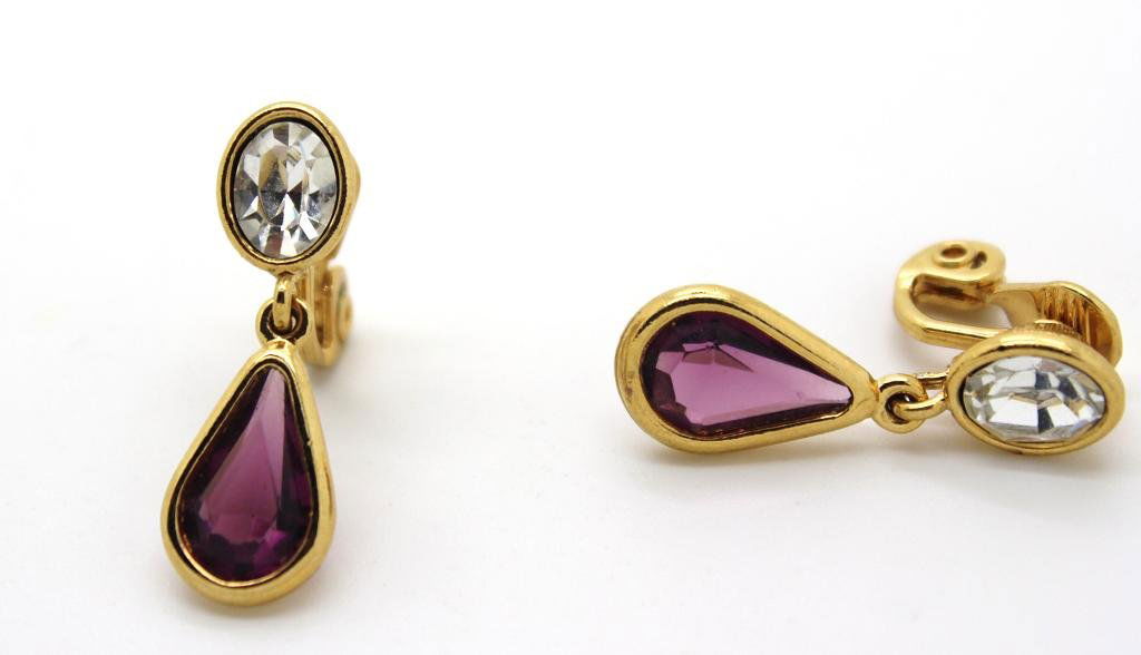 94: Vintage Monet Gold Tone & Rhinestone Drop Earrings: Signed Monet. Clear & purple stone clip earrings. 1 1/2" drop.