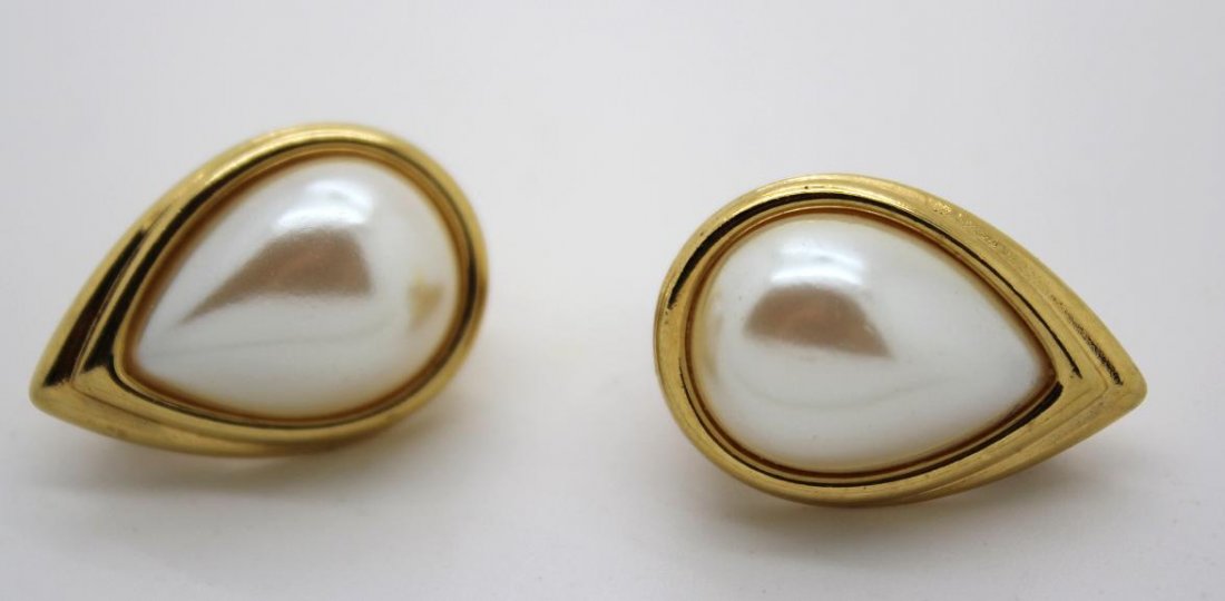 95: Vintage Monet Gold & Faux Pearl Earrings: Signed Monet. Tear drop with faux pearl in center. Clip earring.