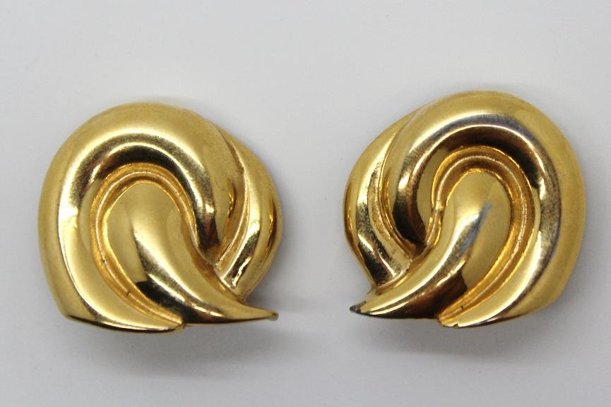 157: Vintage Givenchy Gold Swirl Clip Earrings: Marked Givenchy. 1 1/4" long, 1" wide.Patina on back of clips.