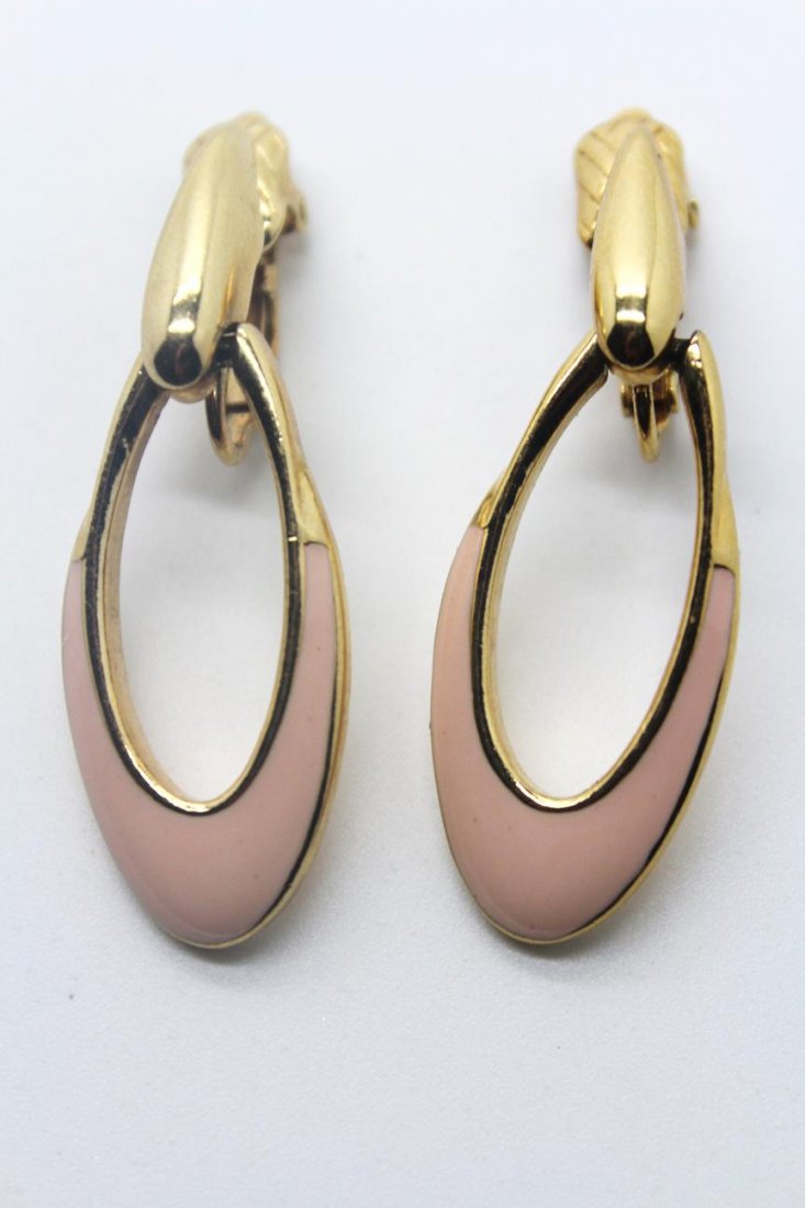 274: Vintage Trifari Gold Tone Pink Enamel Clip Earring: Signed Trifari. Pink enamel & gold tone clip earrings. 2" in length & 3/4" wide.
