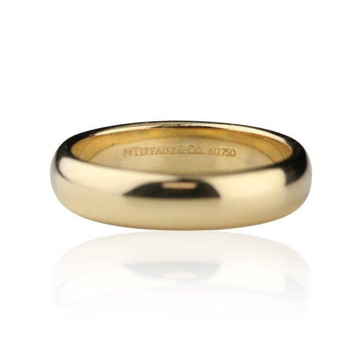 Tiffany & Co. 18KT Yellow Gold Round Band Ring: Tiffany & Co. 18KT Yellow Gold Round Band Ring featuring: 6.8 grams of 18KT yellow gold. Appraisal: $1300.00 Size 8