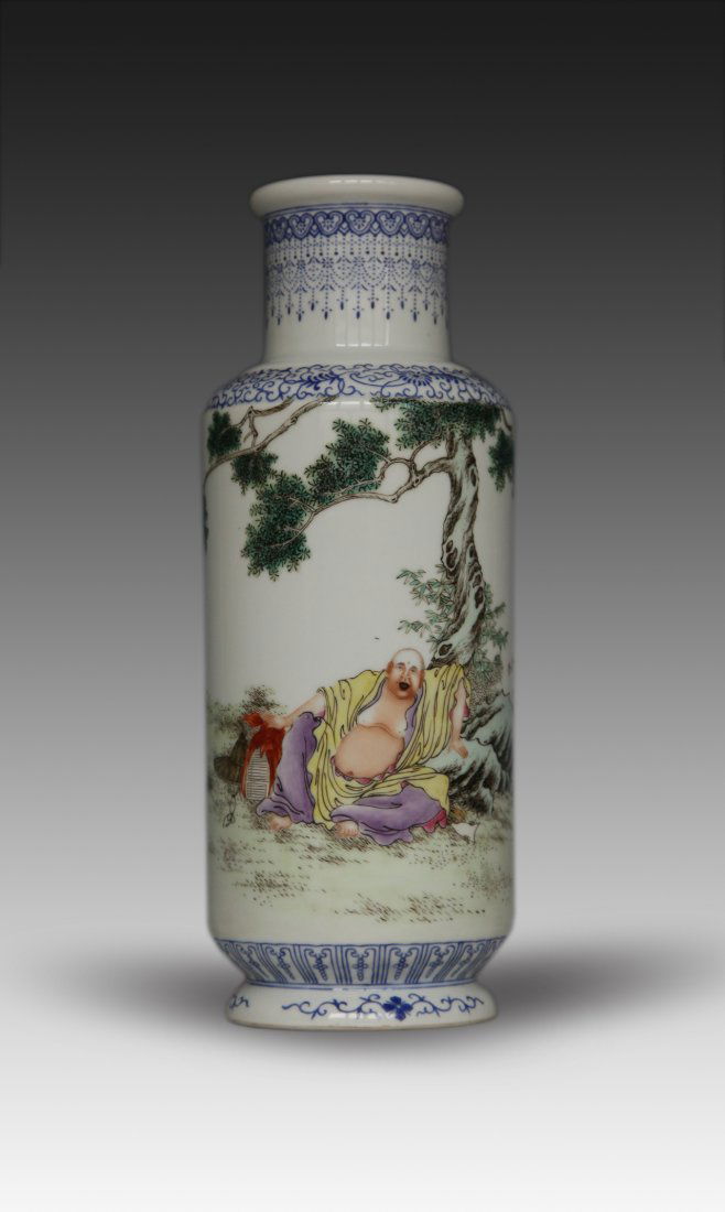 Chinese Enameled Porcelain Vase: Chinese polychrome enameled porcelain rouleau vase, painted with Budai draped in a yellow robe and purple lower garment while seated under a tree with hand resting on a bundle of books set beside a ha