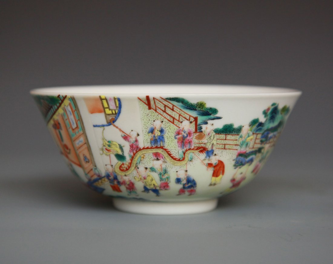 Chinese Famille Rose Glazed Porcelain Bowl: Late 19th/early 20th century. With slightly flared sides, painted on the exterior with boys leading a parade of toy animals and beasts, the interior painted with bats among peaches. Diameter 6 inches.