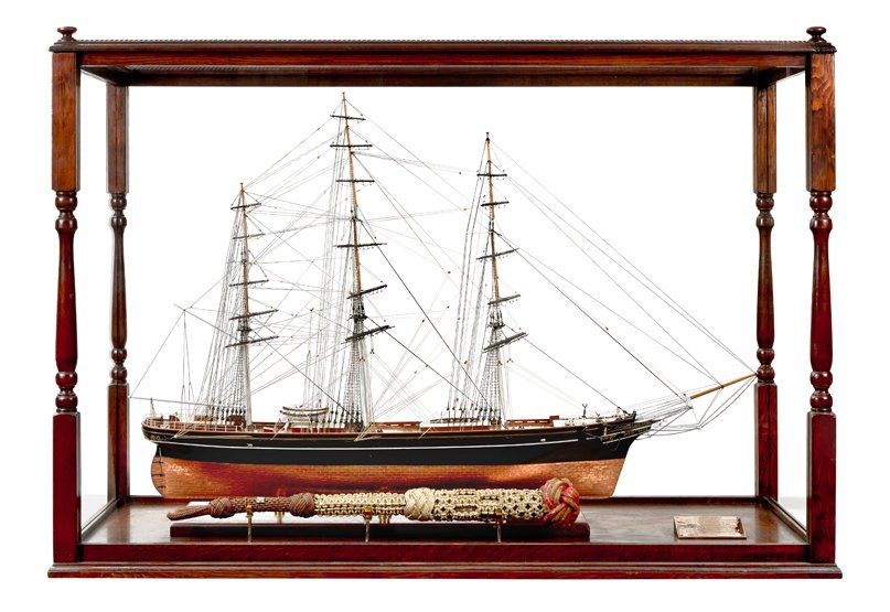 A WELL PRESENTED SCALE MODEL OF THE CUTTY SARK: A WELL PRESENTED SCALE MODEL OF THE CUTTY SARK copper-sheathed below the waterline with carved figurehead, planked deck with fittings including deck rails, bilge pumps, capstan, companionways, cupboar