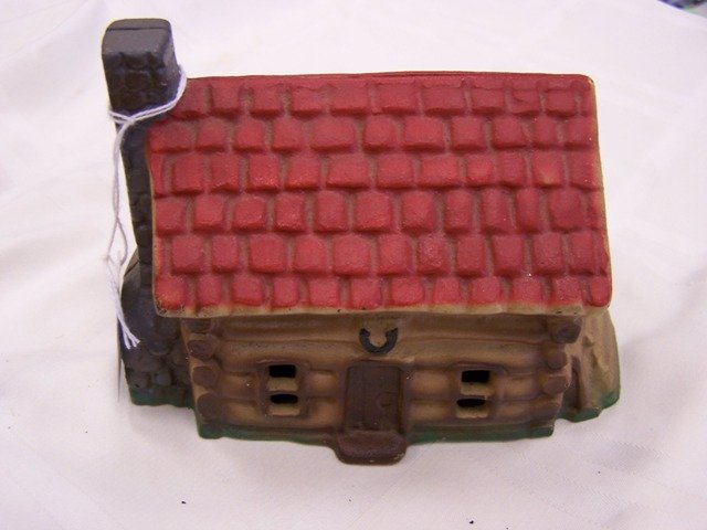Vintage Cast Iron Log Cabin Still Bank: Measures 4 1/2 in tall and 6 in wide nice example with nice colors