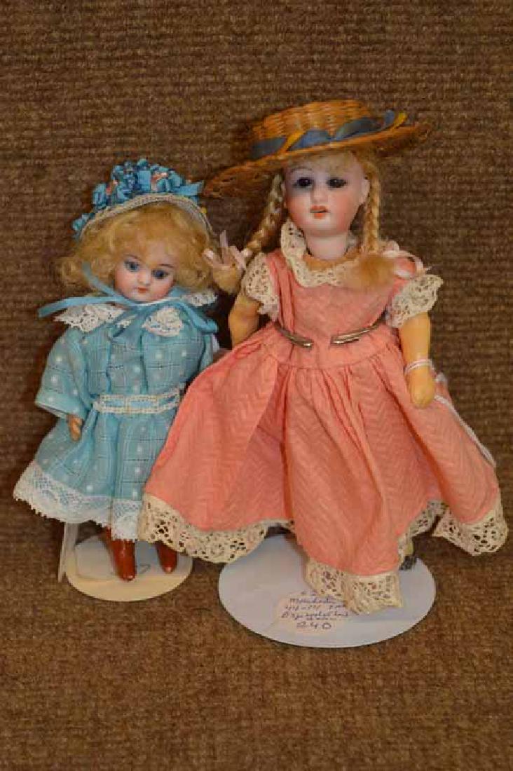 2 Small Bisque Head Dolls on Compo Bodies.: Doll #1-5 1/4" Bisque head doll on compo body, set bllue eyes,O/M w' teeth, blonde mohair wig, tall PTD brow boots, redressed in blue cotton w' lace trim dress & matching straw hat. Doll #2- 6 1/2" Bi