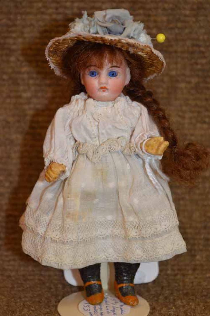 5" Bisque Socket Head w/compo body.: 5" Bisque Socket Head w/compo body. Blue fixed eyes, long auburn mohair wig w/ braids, molded & painted shoes & socks, wearing white dress w/ bonnet.