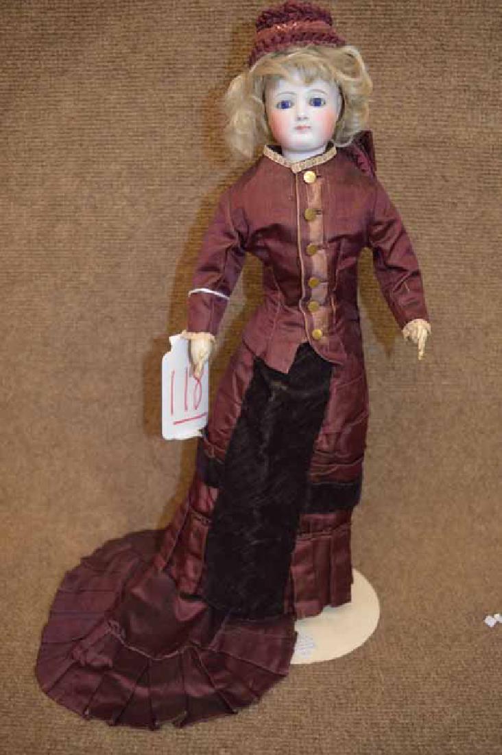 17" French Fashion Bisque Swivel Neck: 17" French Fashion Bisque Swivel Neck, shoulder head w/ older cloth body, fixed blue/ lavender eyes, cork pate, blonde mohair wig, pierced ears ( no earings), leather forearms, wearing wine colored dr