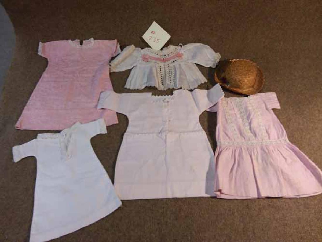 GRP OF CLOTHING TO FIT APROX 17" TO 21" DOLLS: GRP OF CLOTHING TO FIT APPROX 17" TO 21" DOLLS. TO INC: 4 DRESSES & A BLOUSE. PINK SILK FLORAL W/ LACE TRIM; PINK ON WHITE CHECKED W/ RICK RACK TRIM, FRONT BUTTON CLOSURE; WHITE COTTON LACE SHIFT DRES