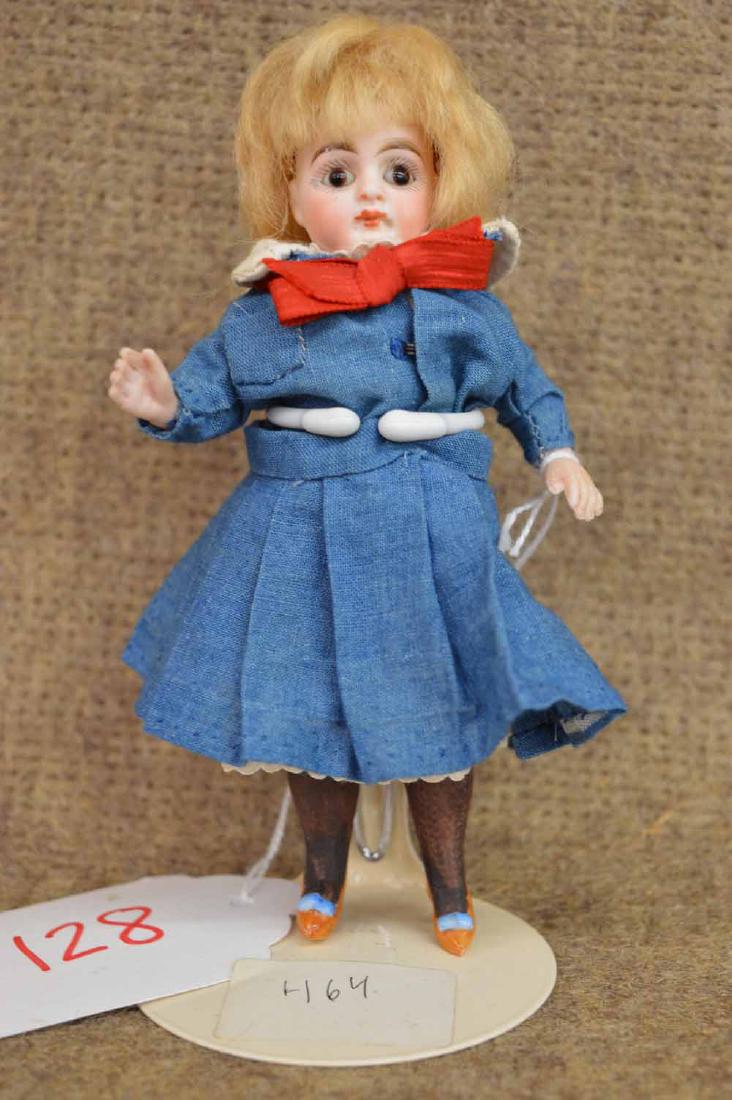 STIFF NECK ALL BISQUE: 6" STIFF NECK ALL BISQUE, JTD AT SHOULDERS & HIPS, MARKED 0, BLONDE MOHAIR WIG, BROWN FIXED EYES, C/M, WEARING BLUE SKIRT & TOP W/WHITE COLLAR & RED BOW, TALL MOLDED PTD DARK BROWN STOCKINGS W/HEELED