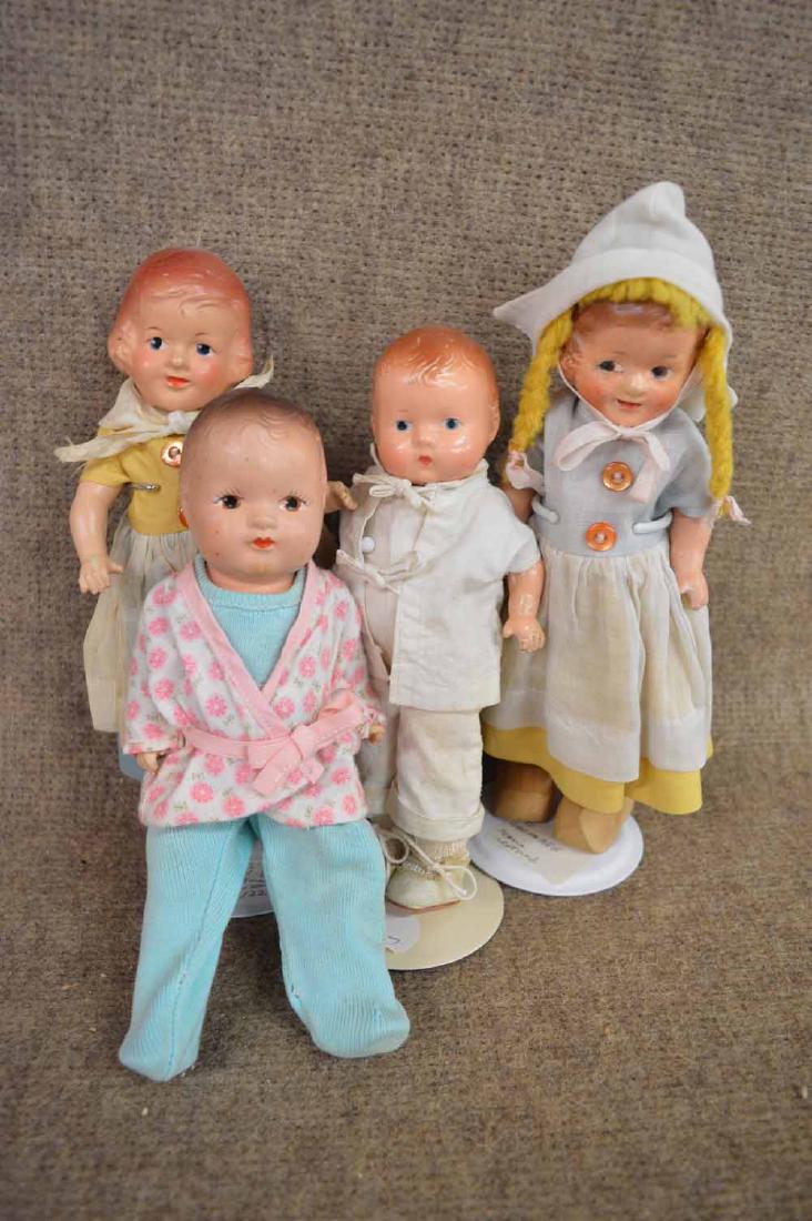 (4) COMPO DOLLS: (4) COMPO DOLLS RANGING FROM 7 1/2" TO 9" TO INC: 7 1/4" EFFANBEE W/SLIGHT DAMAGE TO BACK OF NECK SOCKET, IN WHITE JACKET & JUMPSUIT & WHITE OIL CLOTH PANTS- 8" UNMARKED STIFF NECKED JOINTED AT SHOULD