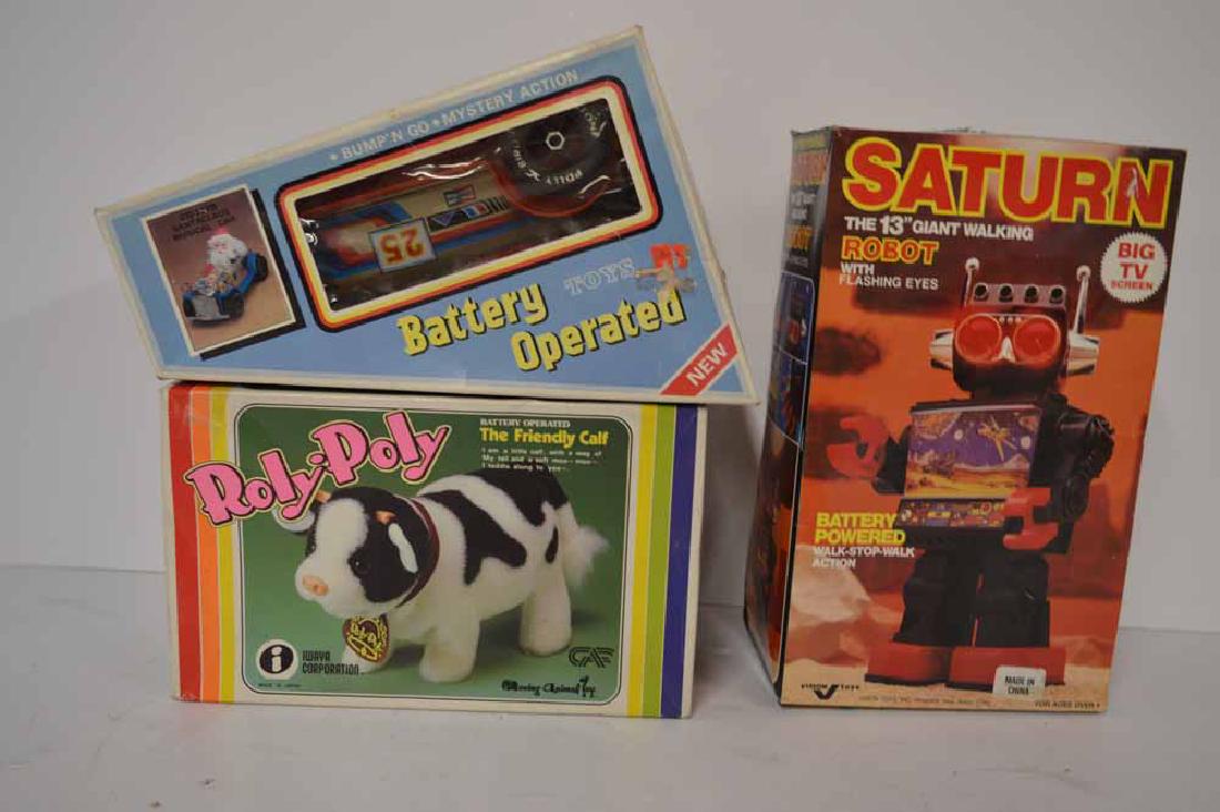 3 BATTERY OPERATED TOYS: GRP OF 3 BATTERY OPERATED TOYS TO INC: SATURN 13" GIANT WALKING ROBOT (MADE IN CHINA), SANTA BUMP & GO RACE CAR (MADE IN TAIWAN) & ROLY POLY CALF (MADE IN JAPAN) ALL UNPLAYED WITH AND IN ORIGINAL BOXE