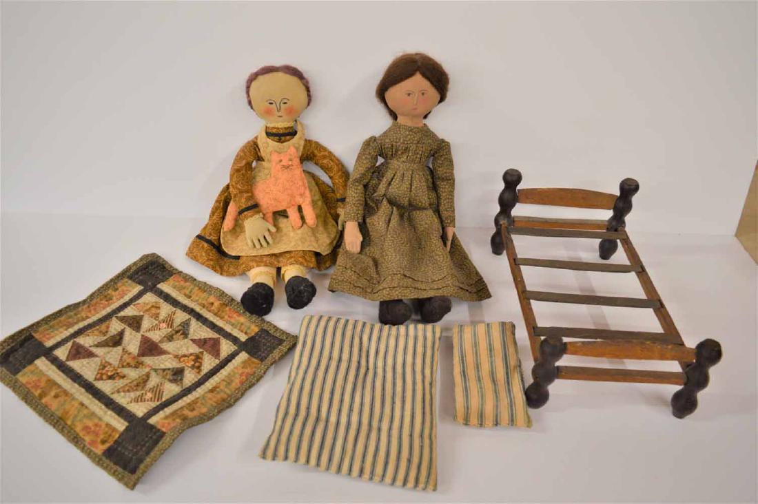 (2) CLOTH GIRLS AND WOODEN BED: (2) CLOTH GIRLS AND WOODEN BED - ONE IS 15" TALL W/BROWN MOHAIR WIG, PTD FEATURES, WEARING BROWN PRINT DRESS -- ONE IS 14" TALL W/BROWN MOHAIR WIG W/SIDE BRAIDS, EMBROIDERED FEATURES, BROWN PRINT DRES