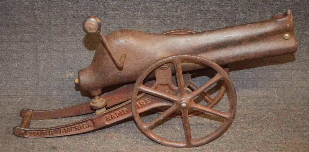 YOUNG AMERICAN CANNON: CAST IRON YOUNG AMERICAN RAPID FIRE CANNON - SHOOTS MARBLES- MADE IN 1907