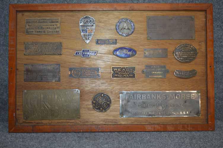 COLLECTION OF SMALL PLAQUES: COLLECTION OF SMALL PLAQUES MOUNTED IN FRAME INCLUDING CHEVROLET, FORD, MADISON, GENERAL ELECTRIC, ATLAS IMPERIAL, WHITE & ENGINE GREY MARINE DIESEL, DESOTO ETC