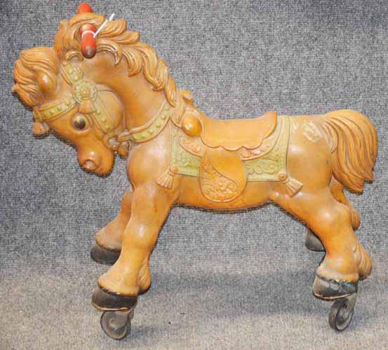 RIDE ON HORSE: CHILD'S RIDE ON HORSE WITH WHEELS MADE OF COMPOSITION IN ORIGINAL PAINT