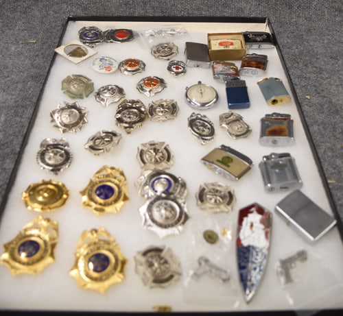 COLLECTION OF BADGES & LIGHTERS ETC: COLLECTION OF BADGES, LIGHTERS, ETC IN SHOWCASE 15" X 20"
