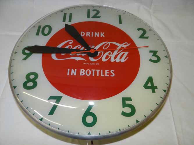 Coca Cola Clock: Drink Coca Cola in Bottles Advertising Clock made by Swihart Products, Elwood, Indiana - 15" Diameter x 4 1/2"D