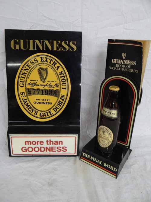 (2) Guiness Beer Items: (1) Guiness Advertising Bottle Display with Guiness Book of World Records (5"W x 14"H x 6"D) & (1) Plastic Guiness Display Sign (8 1/2"W x 15 1/2"H)