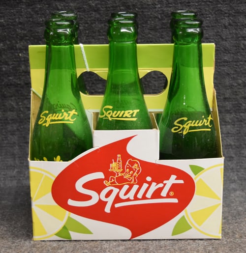 SQUIRT BOTTLES W/CARRIER: SQUIRT CARDBOARD SIX PACK CARRIER WITH ORIGINAL GLASS BOTTLES 7"W X 8 1/4"H X 4 3/4"D