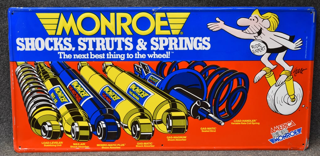 MONROE SHOCK, STRUTS AND SPRING" METAL SIGN: MONROE SHOCK, STRUTS AND SPRING" METAL SIGN - MARKED FORM NO. 9555-S 1086 - PRINTED IN THE USA - BY NEWS AMERICA SYNDCATE 1986 - 36" W X 17 3/4" H