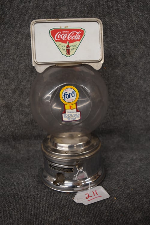FORD GUM & MACHINE CO. GUM BALL 1 CENT DISPENSER: FORD GUM & MACHINE CO. GUM BALL 1 CENT DISPENSER W/COCA-COLA ADVERTISING DECAL ON TOP - METAL AND PLASTIC - MEASURES APPROX. 7 1/2" DIAMETER AT BASE X 16" H