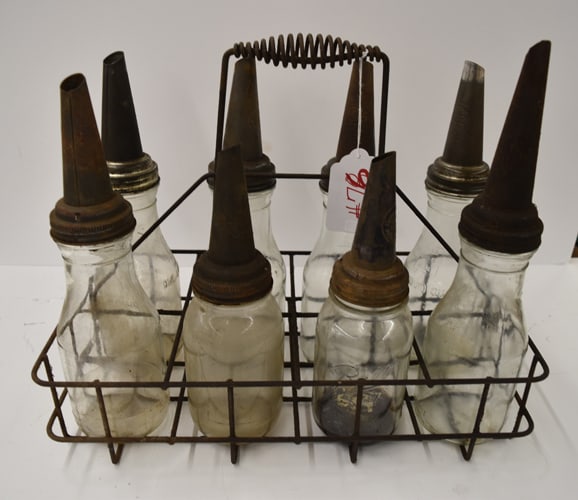 (8) EARLY OIL BOTTLES & RACK: GROUPING OF (8) EARLY OIL BOTTLES - ONE QUART W/SPOUTS IN WIRE RACK