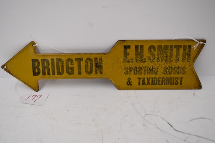 SMITH TAXIDERMY SIGN: E.H. SMITH SPORTING GOODS AND TAXIDERMIST TIN ARROW SIGN - ERIC & SON ON SIDE
