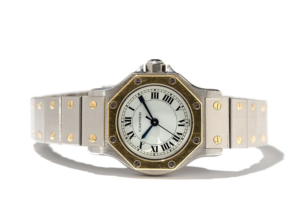 Cartier Santos Women’s Watch, Switzerland, Around 1990: Cartier Santos women’s watch Switzerland, around 1990 Automatic movement, hour, minute, second White dial, blued hands Watch case, crown and folding clasp of stainless steel, bezel of 18K gold Caboc