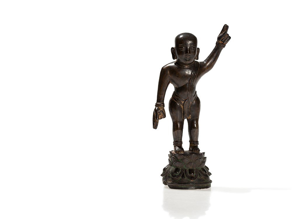 Bronze Figure of the Boy Buddha on a Double Lotus: Bronze China, Ming Dynasty (1368-1644) Standing on a double lotus throne Scantily clad Remains of leaf gilding Rich patina Total height: 20 cm Good condition Provenance: from a German private collecti