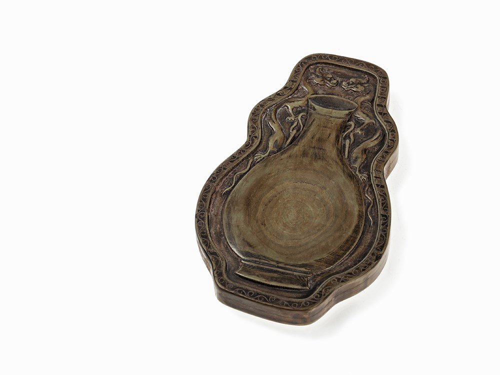 Greenish Inkstone in Vase shape, surrounded by Dragons,: Greenish, striated inkstone, presumably zitan wood China, Qing dynasty (1644-1912) In the form of a pear shaped vase flanked by two confronting chilong dragons Tendrils on the edge Inkstone together w