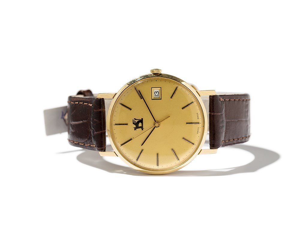 Eterna Wristwatch, Switzerland, Around 1970: Eterna wristwatch Switzerland, around 1970 Quartz movement, 7 jewels, hour, minute, second, date Gold dial, black and one gold hand Watch case of 18K gold Brown leather strap with pin buckle Watch cas