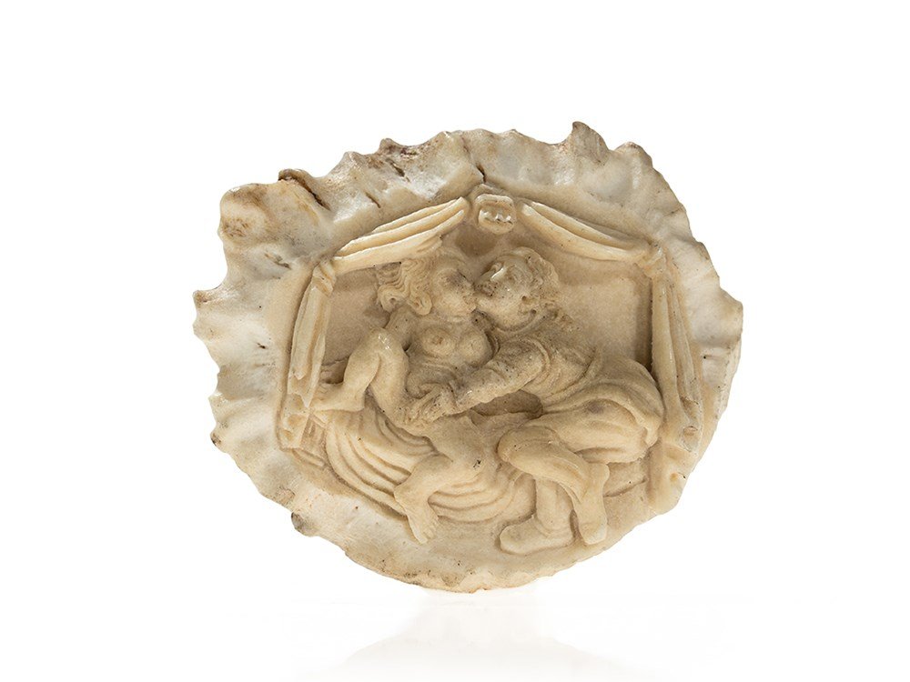 A Finely Carved Antler Rosette with Erotic Scene,: Antler horn Presumably Germany, 18th / early 19th Century With an erotic scene Fine carving Diameter: 8 cm Good condition This finely carved antler horn rosette was made sometime in the 18th or the ea