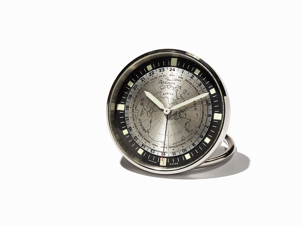 Imhof Worldtimer Table Clock, Switzerland, Around 1965: Imhof Worldtimer table clock Switzerland, around 1965 Manual wind movement, 8 days, hour, minute, second, world time Silver dial, silver hands Watch case of stainless steel Watch case no. 1576360 Case