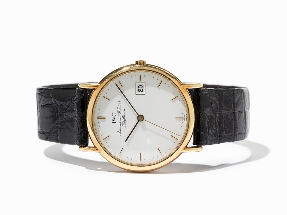 IWC Gold Wristwatch, Switzerland, Around 1990: IWC gold wristwatch Switzerland, around 1990 Quartz movement, hour, minute, second, date White dial, silver hands Watch case of 18K gold Original, black leather strap with original, gold-plated pin bu