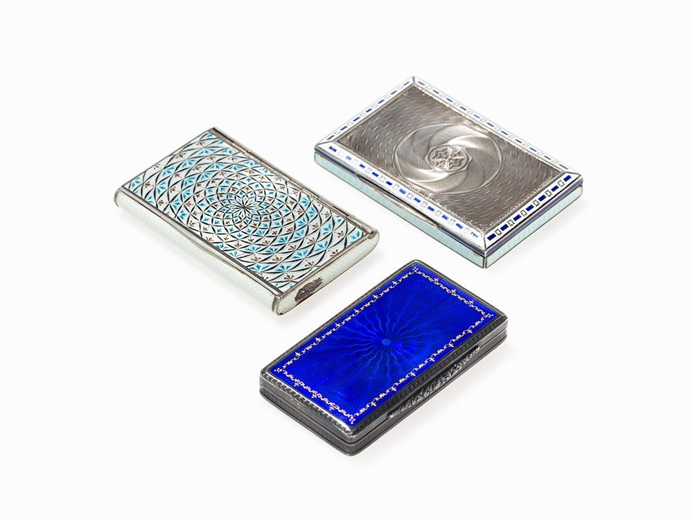 Three Silver & Enamel Tobacco Boxes, Hungary, circa: Silver, enamel, guilloche and punched decor, gilt interior (Austria-) Hungary, circa 1900-1930 Box 1: lid and base with blue enameled sun decoration and golden border, hinged lid with thumb rest in re
