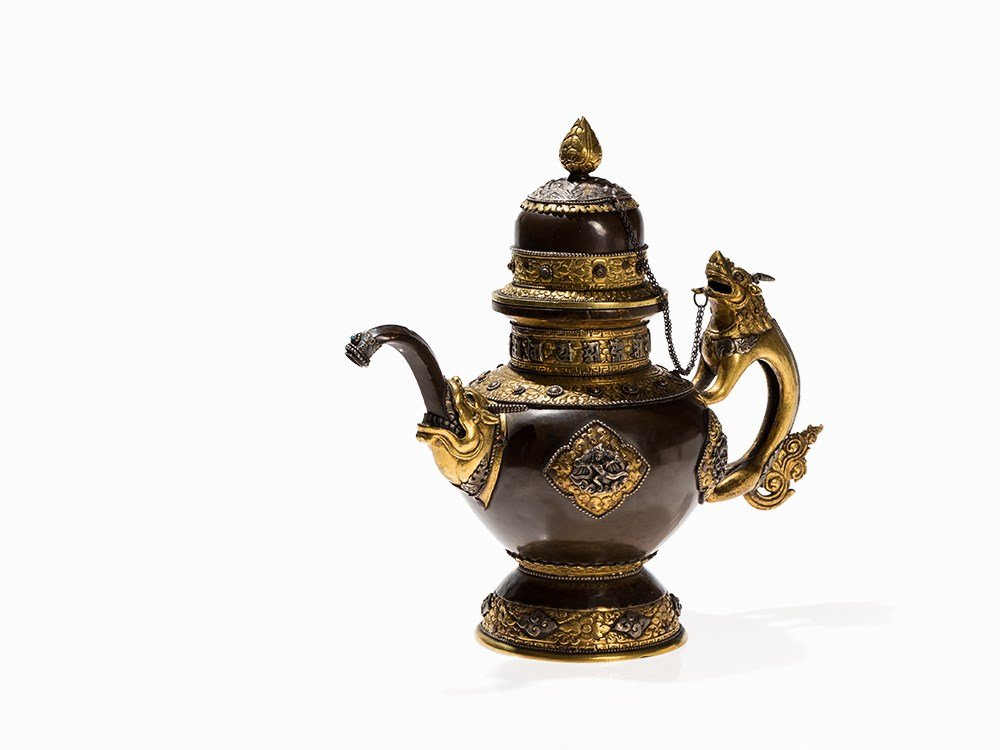 Copper Bhumpa, Ritual Ewer with Gilt Repoussé,: Copper, partly gilt and silver plating and stones China/Tibet, 19th/20th century Fine repoussé elements and richly decorated with Buddhist symbols in relief The ritual jug, called bhumpa, was used fo